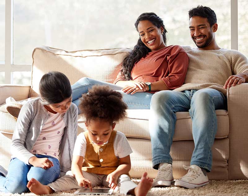 a family sitting in the living room